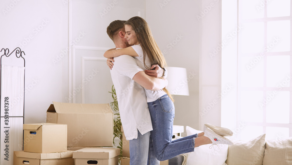 Lovely couple dancing in new empty flat