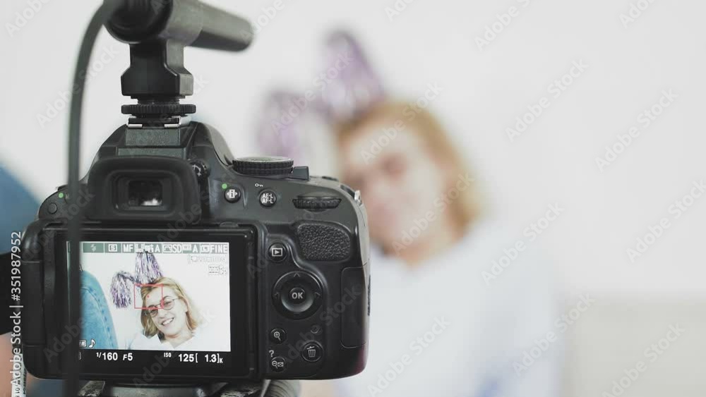 Funny girl recording video on digital camera at home. Vlogging and social media concept Funny girl recording video on digital camera at home. Vlogging and social media concept