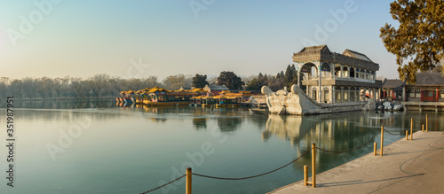 View from the pier in the summer palace on the marble boat of Empress Cixi moored on the lake. photo