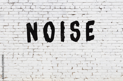 Word noise painted on white brick wall photo