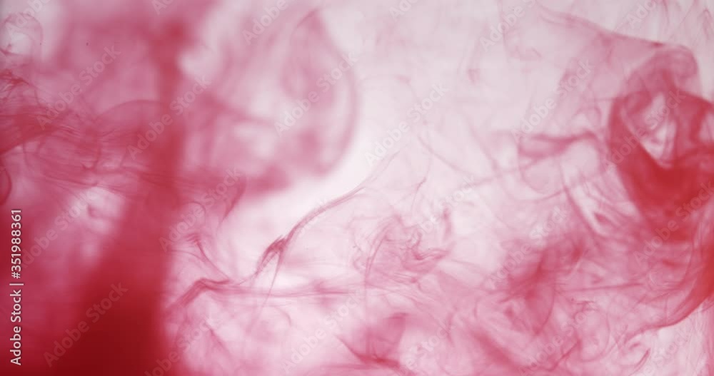 Cloud of red color ink in water isolated on white. Abstract design and texture. Cloud of red color ink in water isolated on white. Abstract design and texture.