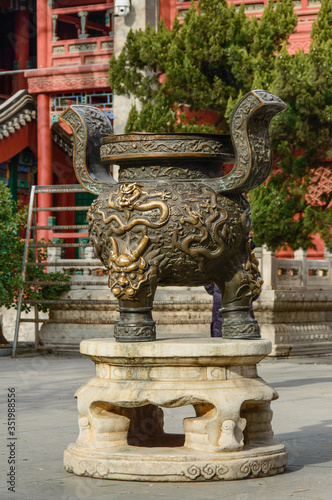 Decorated bronze hearth in front of the entrance to the building.