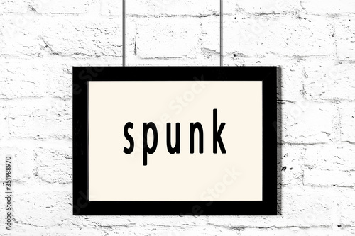 Schilderij op canvas Black frame hanging on white brick wall with inscription spunk
