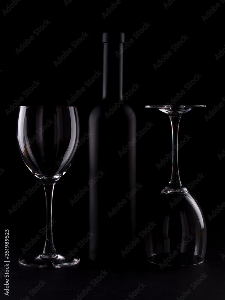 Wine glasses on black backround and wine bottles Wine glasses on black backround and wine bottles