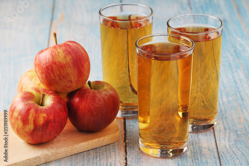 Glasses with apple juice and ripe apple