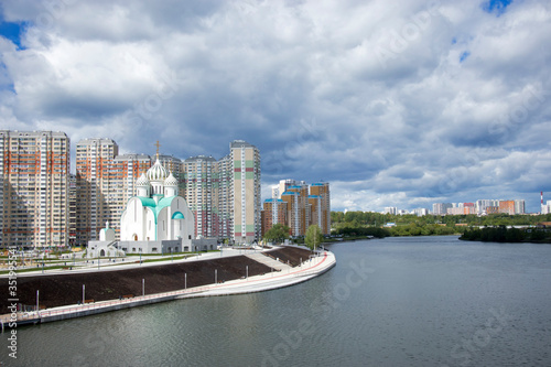 Construction of Moscow river embankment and St. Nicholas Church in new area of Pavshinsky floodplain photo