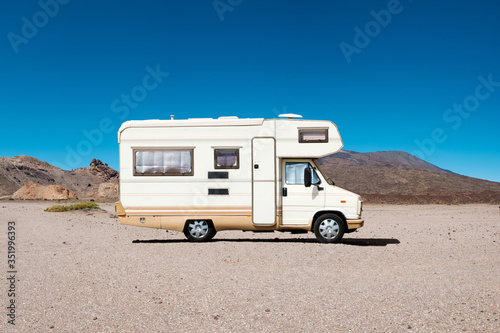 vintage camping bus, rv camper van in desert landscape -
