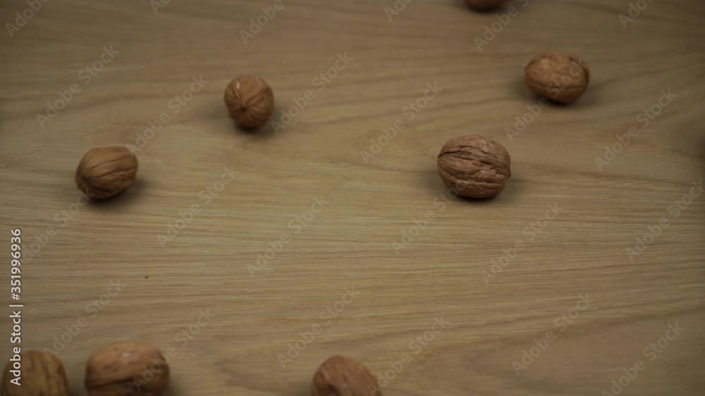 Walnuts Fall And Fill Screen. Organic Walnuts falling on wooden background. Slow motion. Walnuts Fall And Fill Screen. Organic Walnuts falling on wooden background. Slow motion.