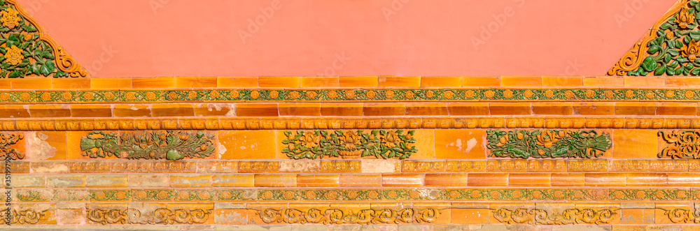 Colorful decorative tiles, old decorations on the wall of a building in the forbidden city.