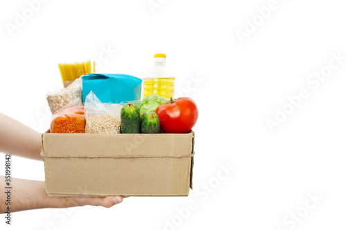 Food donations box isolated on white background. Box with oil, pasta, cereals, fruits, vegetables. 