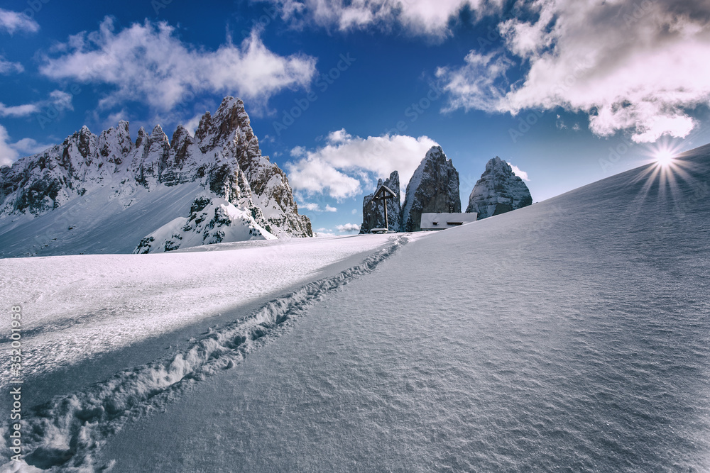Winter view in the Dolomites, North Italy, South Tyrol, nature park Tre Cime. Winter Alps, christmas card. Winter hiking, traces on snow. Rifugio Locatelli. Dolomiti.