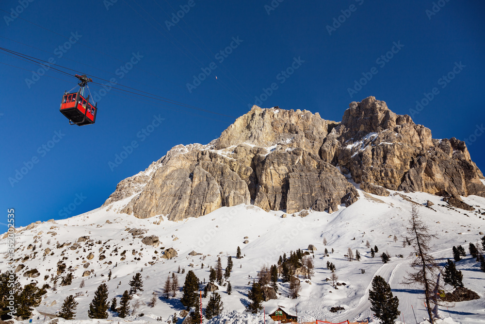 Red Cable car of Lagazuoi mountain seen from Passo Falzarego in winter. Dolomites near Cortina d'Ampezzo, Veneto, Italy. Dolomiti Belluno, Cortina Ski resort.