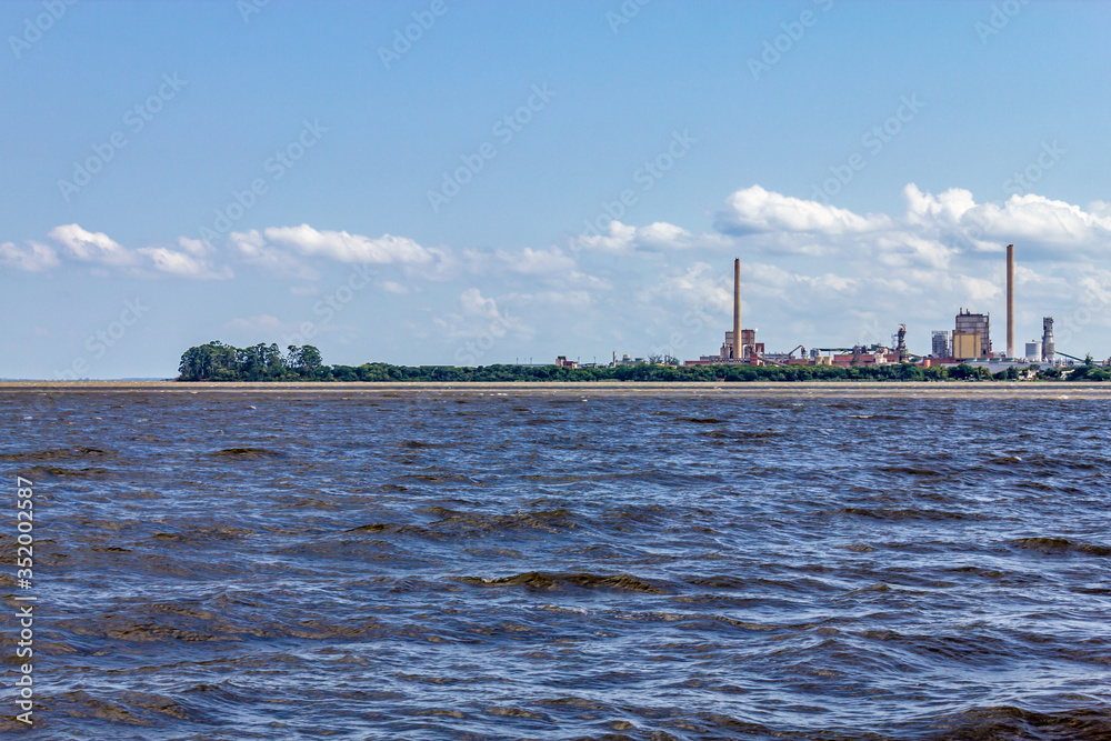 Naklejka premium Industrial towers in Guaiba city and Guaiba lake