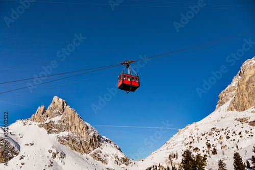 Obraz na płótnie Red Cable car of Lagazuoi mountain seen from Passo Falzarego in winter. Dolomites near Cortina d'Ampezzo, Veneto, Italy. Dolomiti Belluno, Cortina Ski resort. w salonie