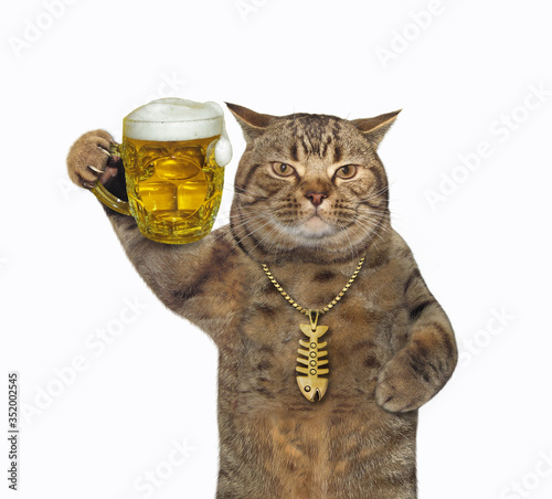 Canvas Print The beige cat in a gold fish-bone pendant is drinking light beer from a mug