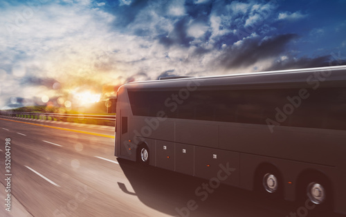 Fotografia Grand tour bus moving fast on the highway at sunset