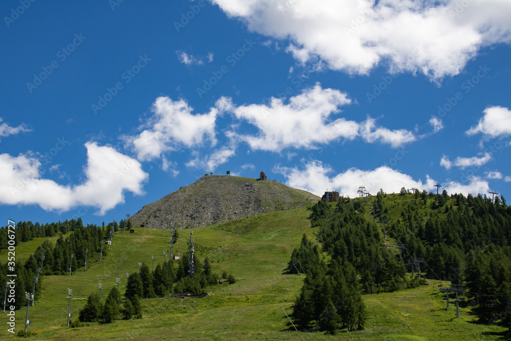 mountain landscape with mountain rich vegetation and blue sky with a few white clouds