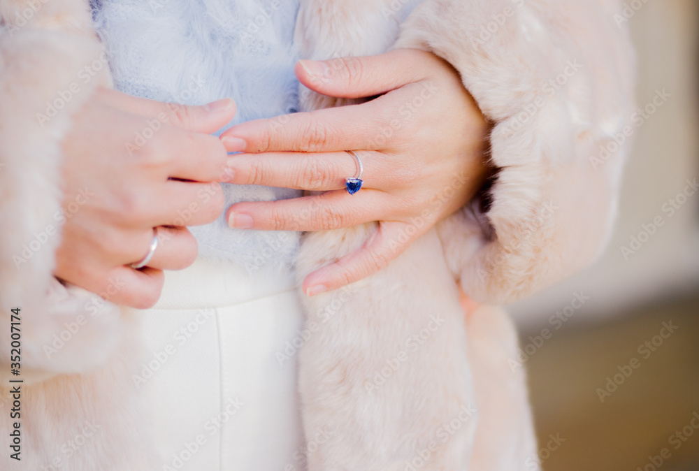 Close up of a woman's hand with blue sapphire engagement ring Close up of a woman's hand with blue sapphire engagement ring