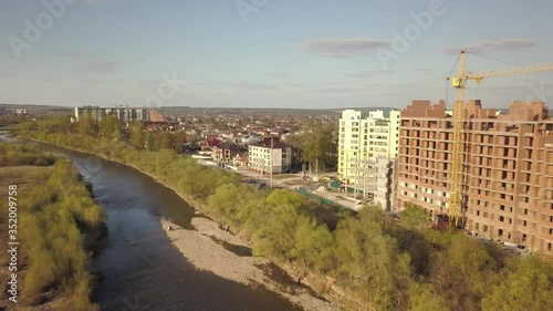 Aerial view of Ivano-Frankivsk city, Ukraine with Bystrytsia river and tall residential buildings under construction. photo