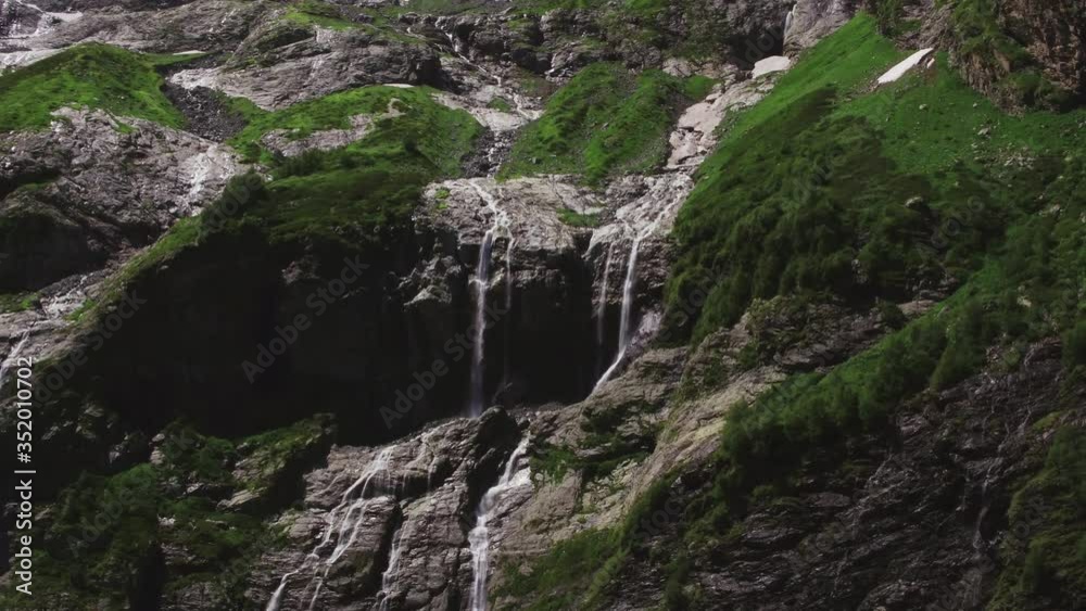 Cascade waterfall in Caucasian Mountains / High altitude Sofiyski rocky fall in nature reserve in Zelenchuksky district. Aerial drone mid shot at summer sunny day Cascade waterfall in Caucasian Mountains / High altitude Sofiyski rocky fall in nature reserve in Zelenchuksky district. Aerial drone mid shot at summer sunny day