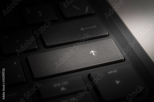 computer or laptop keyboard key with up arrow, enter, growth up, close-up © daniiD
