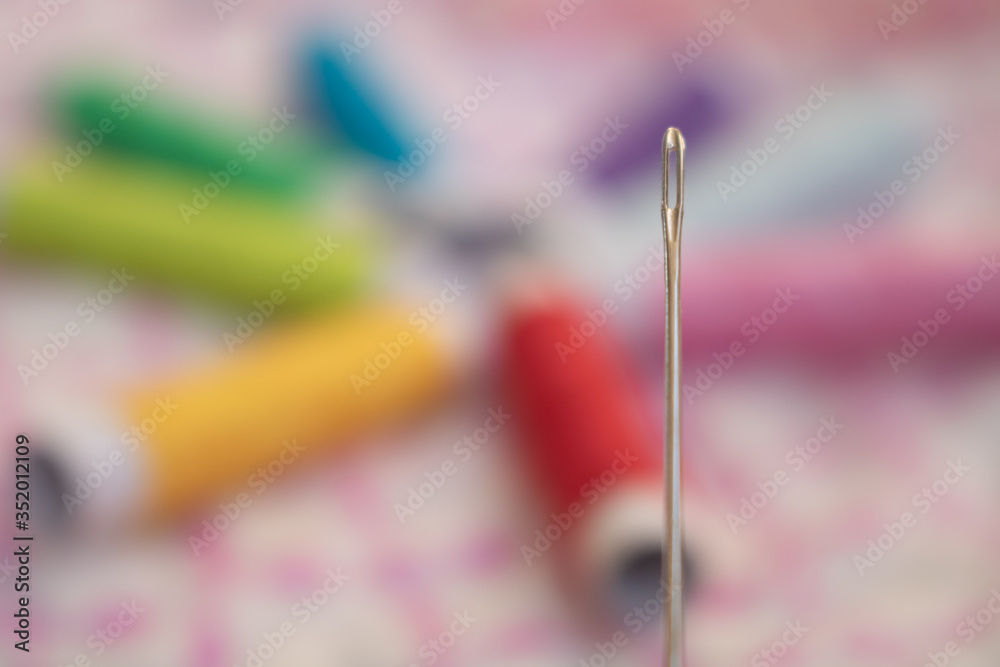 Needle and colorful threads Needle and colorful threads