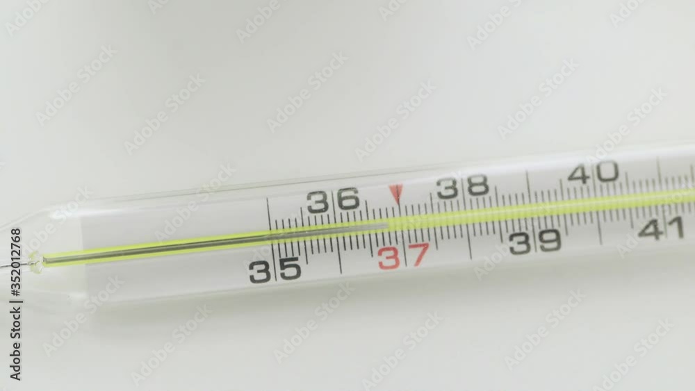 Glass mercurial thermometer takes temperature on white background Corona. Covid-19 Glass mercurial thermometer takes temperature on white background Corona. Covid-19