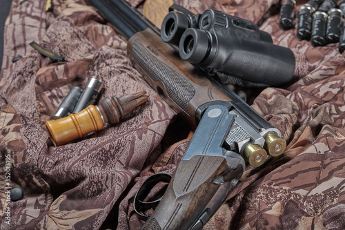 12-gauge hunting shotgun, binoculars and old duck call