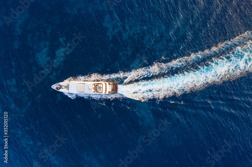 Aerial view of floating ship on blue Adriatic sea at sunny day. Fast ship on the sea surface. Seascape from the drone. Travel - image © biletskiyevgeniy.com