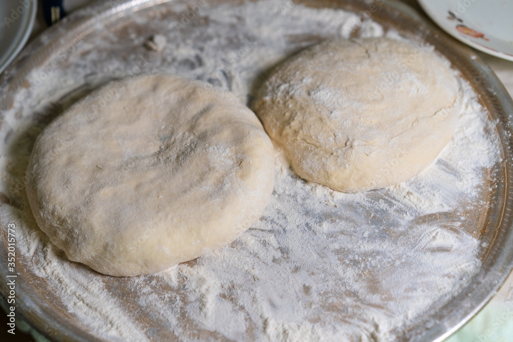 Cooked dough lies on flour for further baking Cooked dough lies on flour for further baking