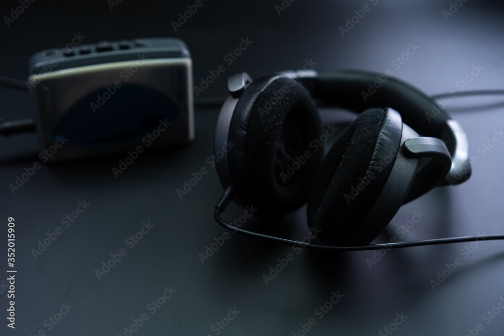 Cassette player with headphones on a black background Cassette player with headphones on a black background