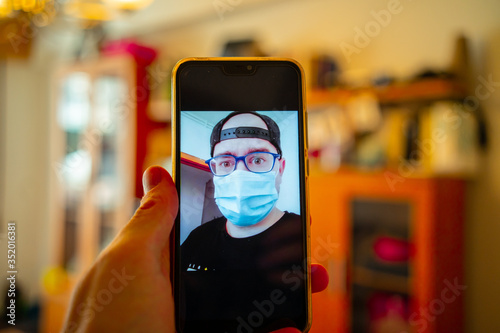 Young man is talking by video call in mask.