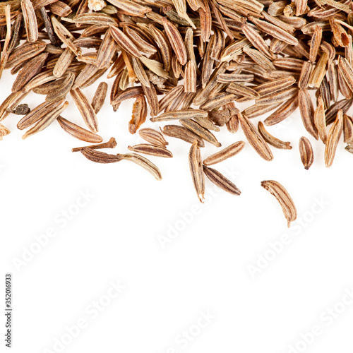 Heap of caraway seeds isolated on a white background. Macro photography.