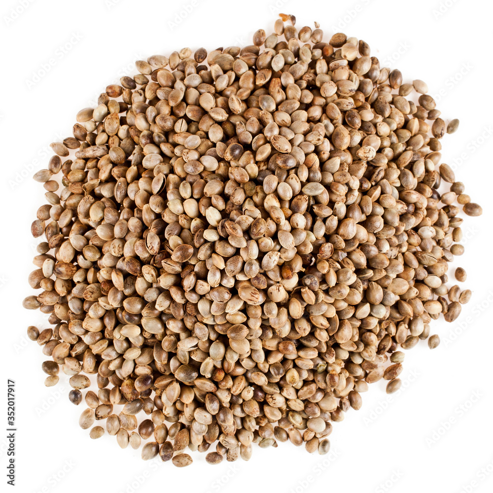 Heap of cannabis seeds isolated on a white background. Top view. Heap of cannabis seeds isolated on a white background. Top view.