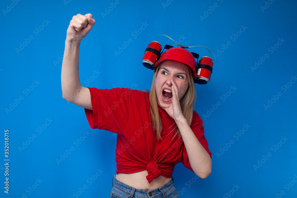 crazy girl a fan in a red uniform and a beer hat is rooting for his team and screaming, a cheerleader is happy about the victory crazy girl a fan in a red uniform and a beer hat is rooting for his team and screaming, a cheerleader is happy about the victory