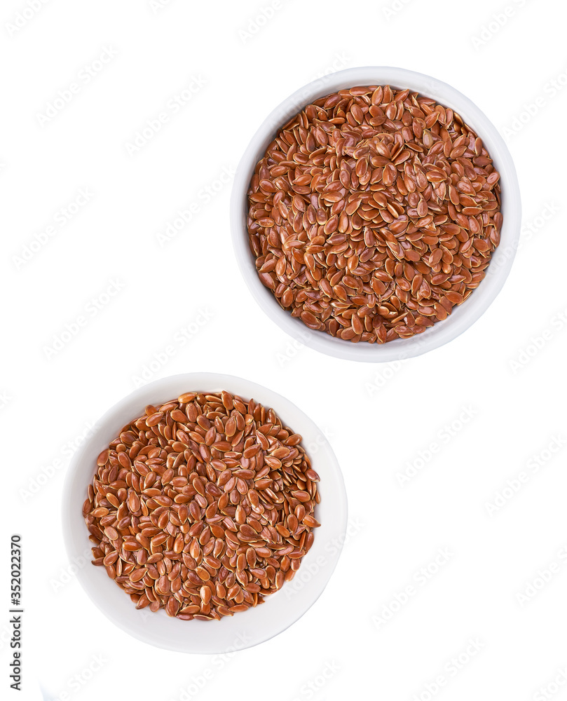 flaxseed in a ceramic bowl isolated on a white background, top view. flaxseed in a ceramic bowl isolated on a white background, top view.