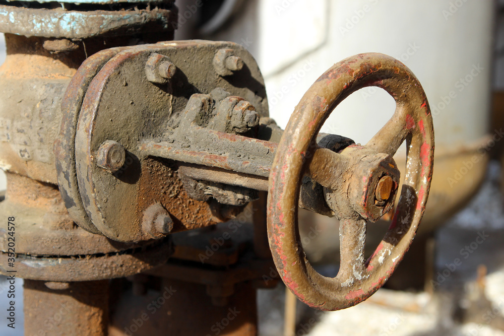 An old rusty dirty control valve on the pipe An old rusty dirty control valve on the pipe