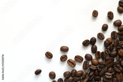Brown coffee beans isolated on white background © Andrzej