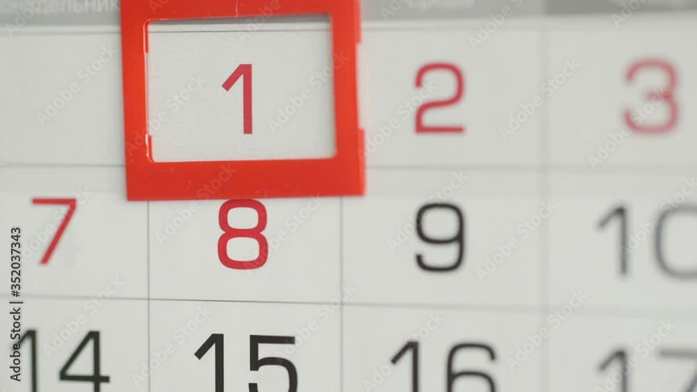 Woman's hand in office changes date at wall calendar. Woman's hand in office changes date at wall calendar.