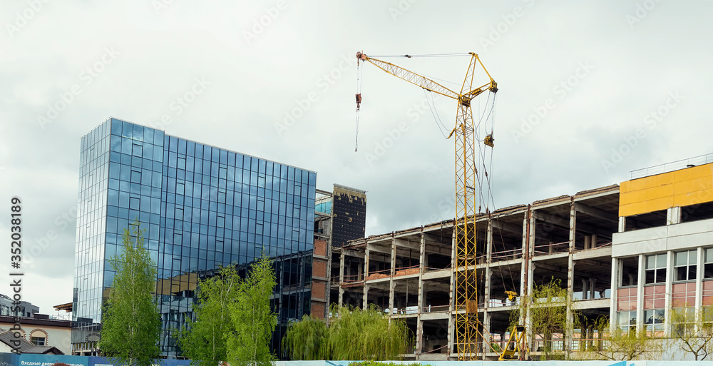The construction of a multi-story building. Crane at a construction site The construction of a multi-story building. Crane at a construction site
