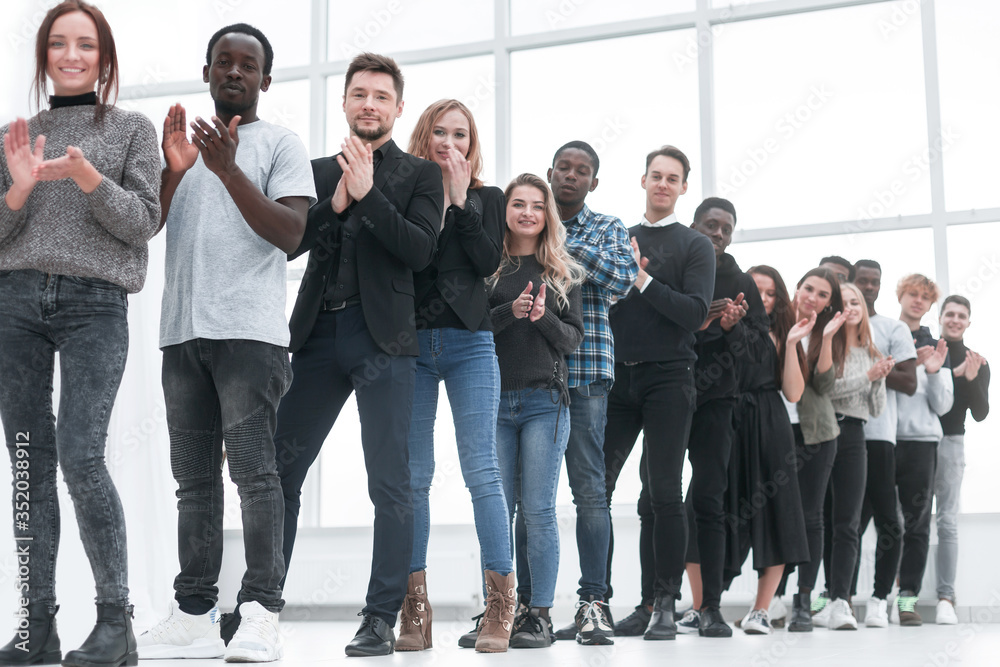 diverse young people applaud standing in line