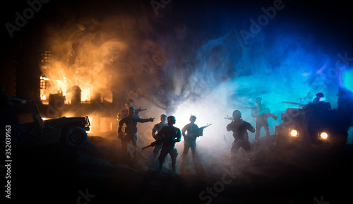 War Concept. Battle scene on war fog sky background, Fighting silhouettes Below Cloudy Skyline at night.