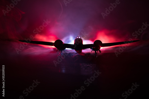 German Junker (Ju-88) night bomber at night. Artwork decoration with scale model of jet-propelled plane in possession. photo