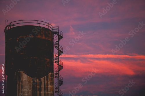 oil refinery at sunset