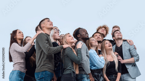 large group of diverse young people looking up hopefully photo