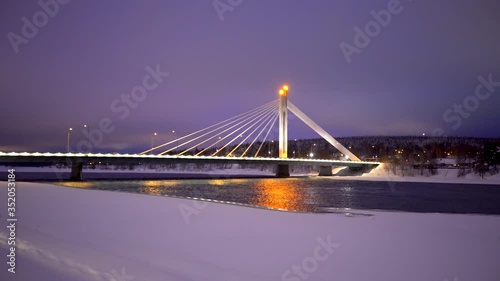 Kemijoki river in Rovaniemi with Ounaskoski Railway bridge and Lumberjack's Candle Bridge during winter, Finland.