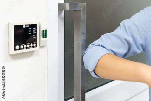 Wallpaper Mural woman using elbow to open the door to avoid covid-19 or coronavirus infection. social distancing and new normal concept Torontodigital.ca