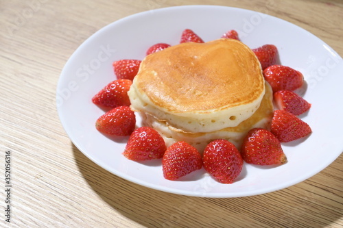 pancake and strawberry fruit sweet dessert food put on breakfast table