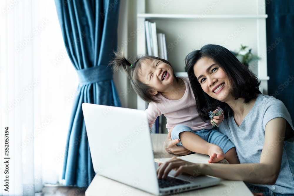 Asian mother use computer, working from home with little baby girl. Asian mother use computer, working from home with little baby girl.