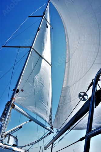 Sail tack with a sailing yacht in the wind with blue sky.